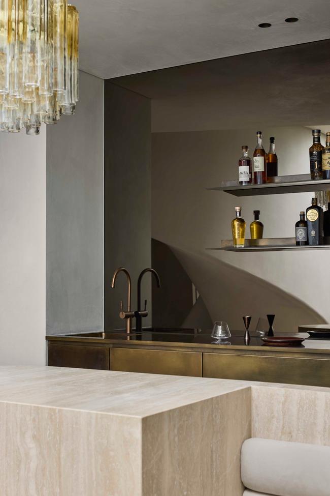 Bar area with brass fixtures and bottle shelving