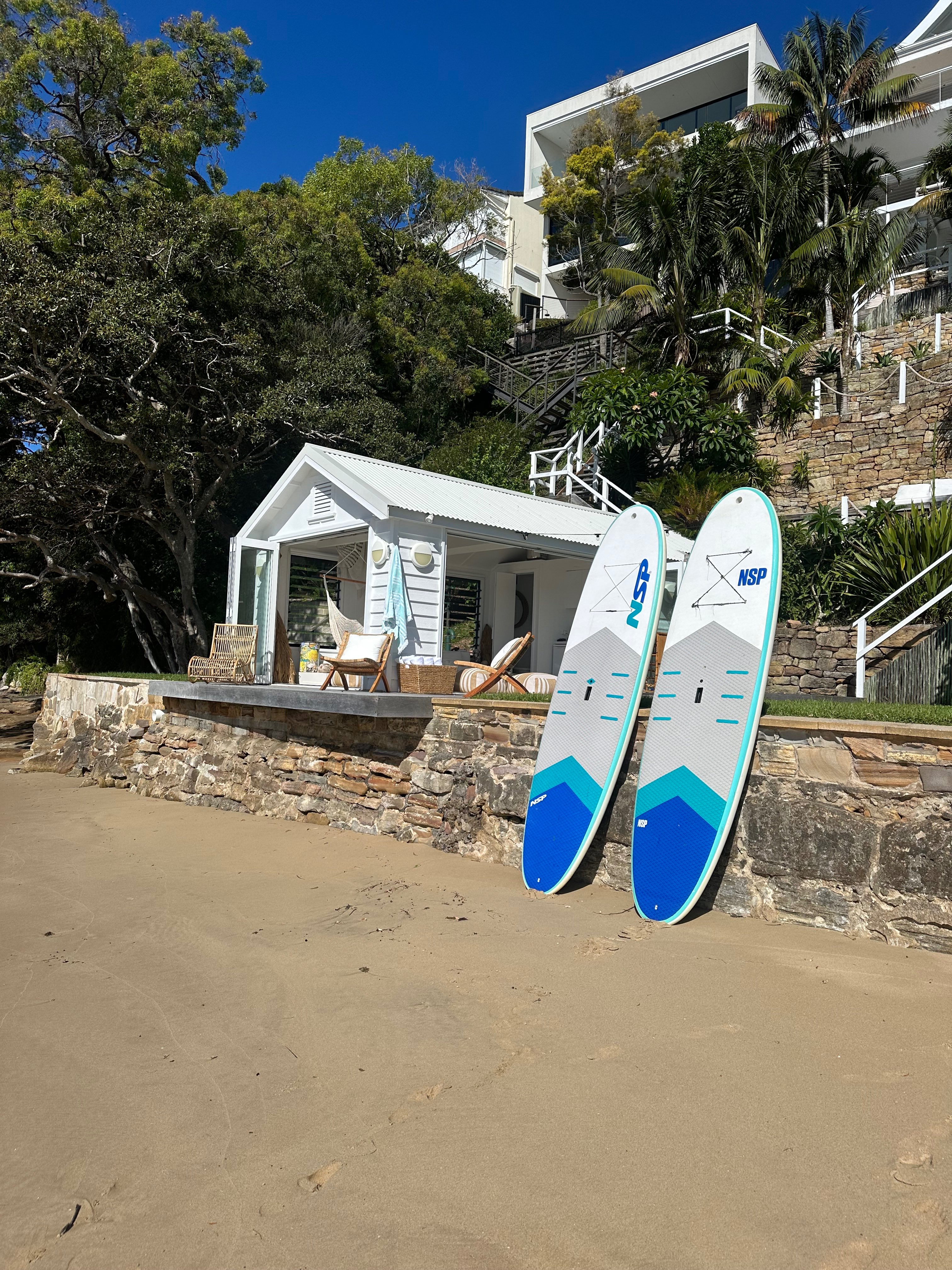 Beach with paddle boards and cabana