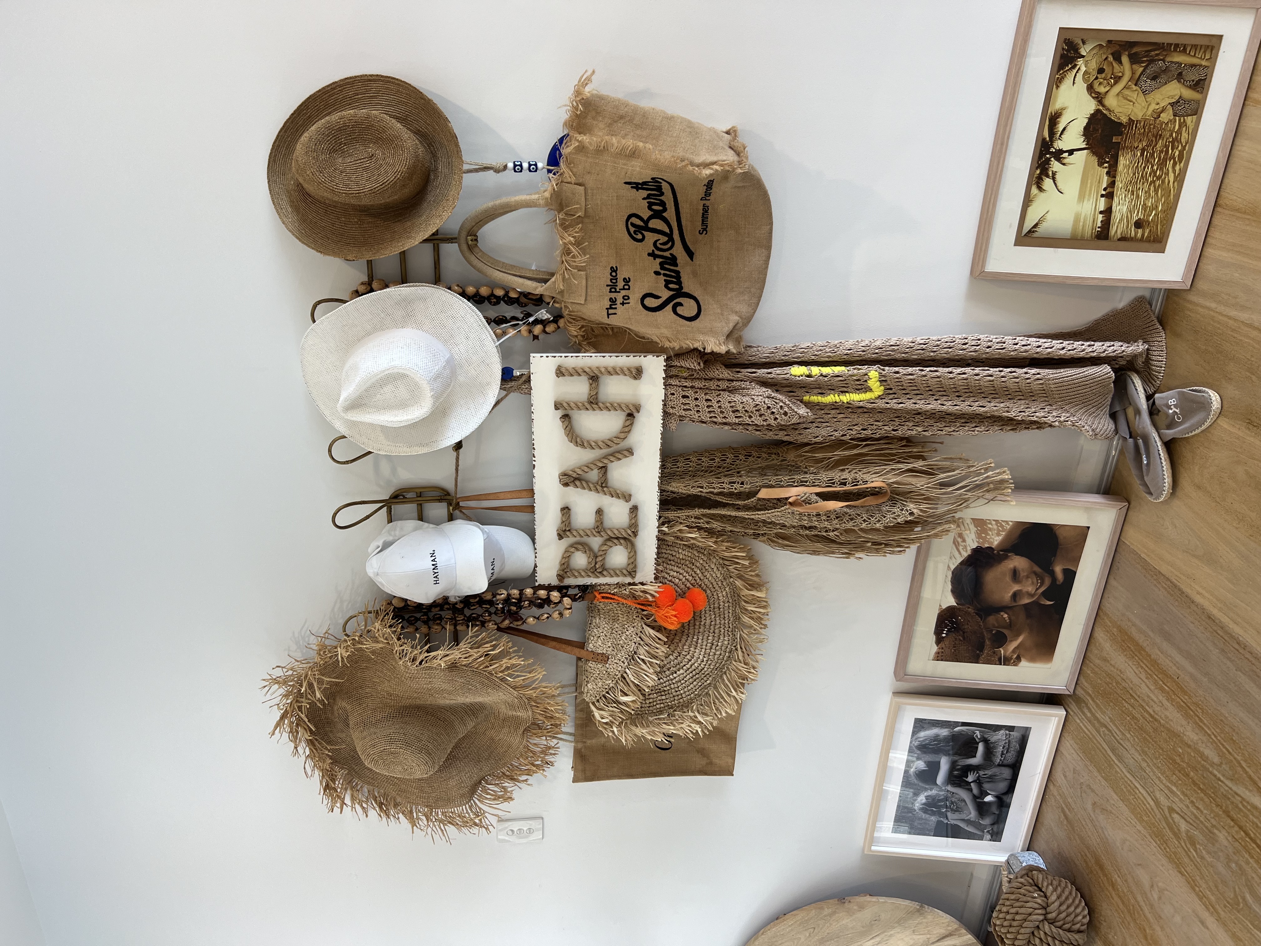 Beach wall decor with hats and Saint Barth bag