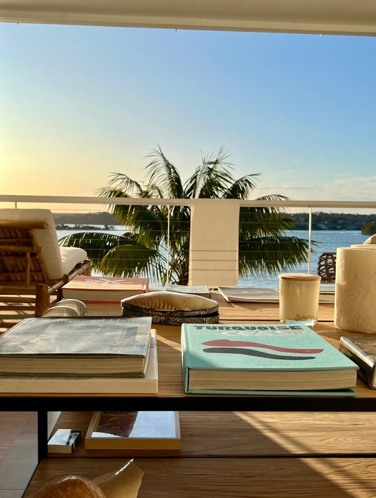Sunset balcony with palm trees and water views