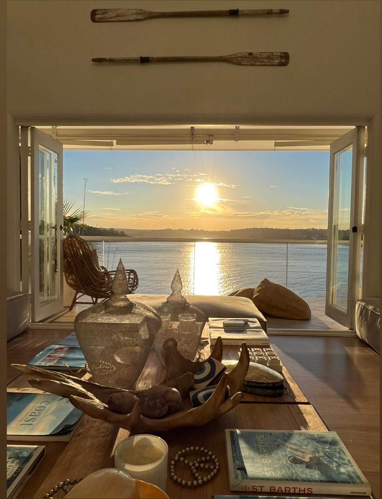 Sunset view through open doors with decorative oars