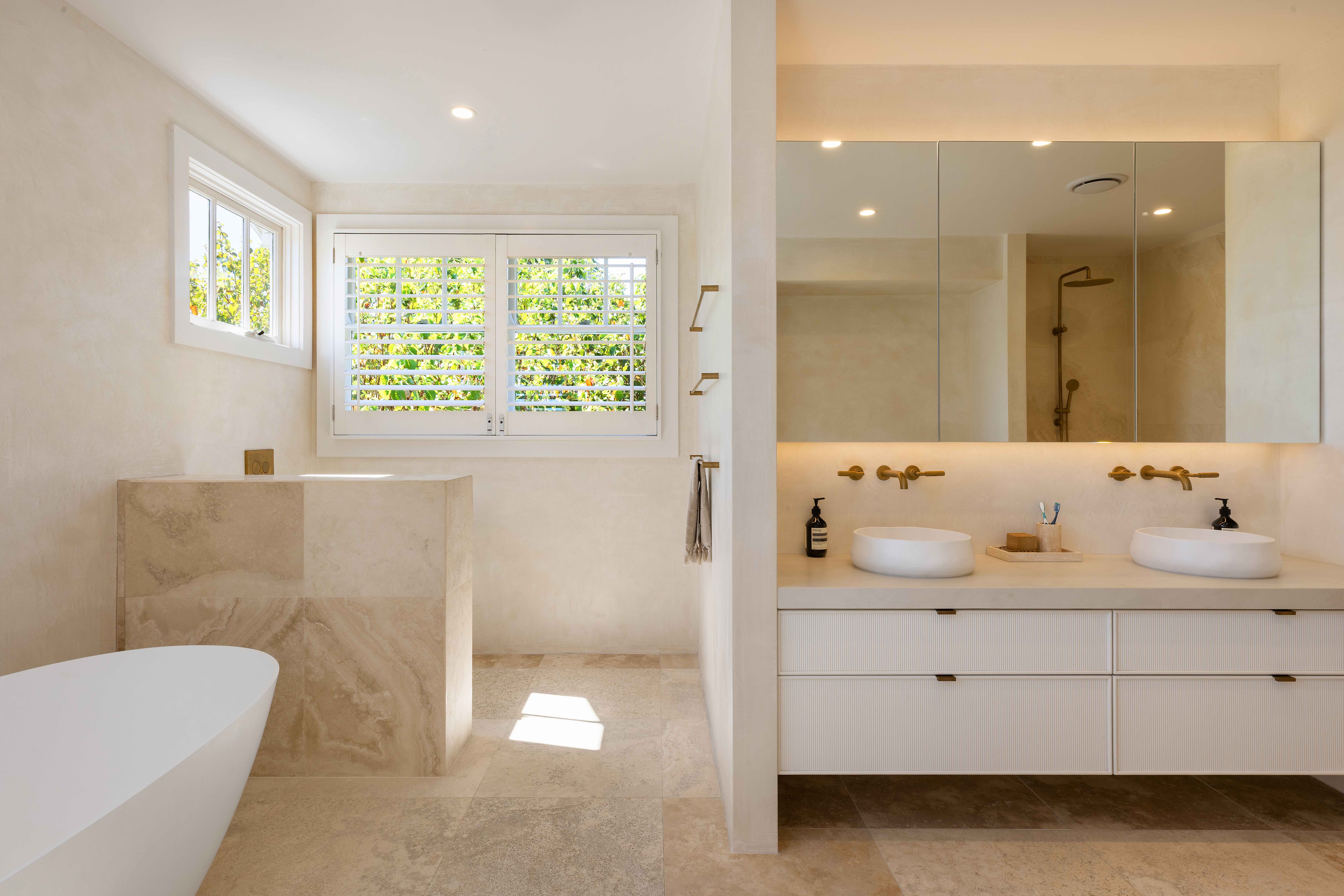 Luxury bathroom with double vanity and brass fixtures