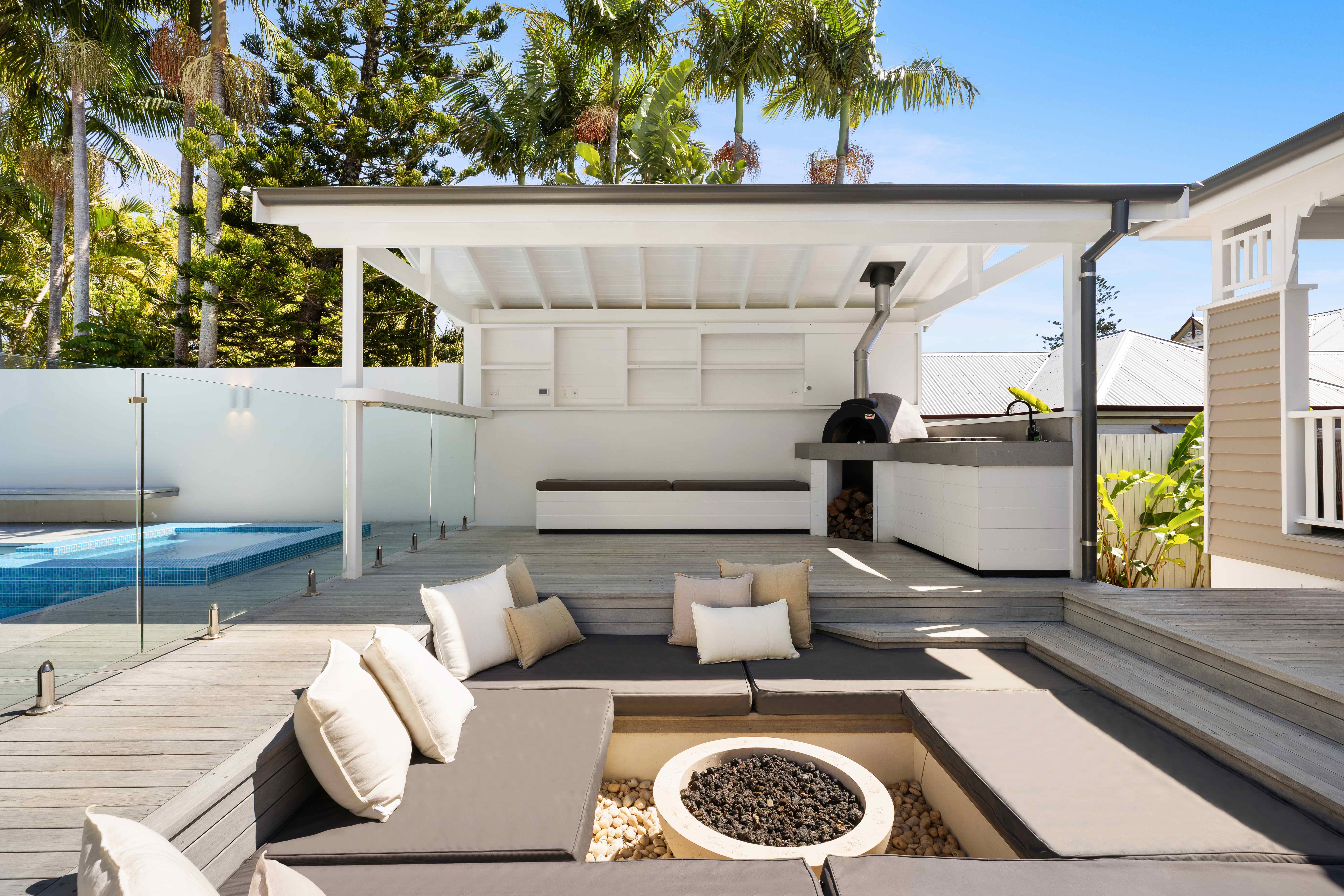Outdoor entertaining area with sunken fire pit and pizza oven