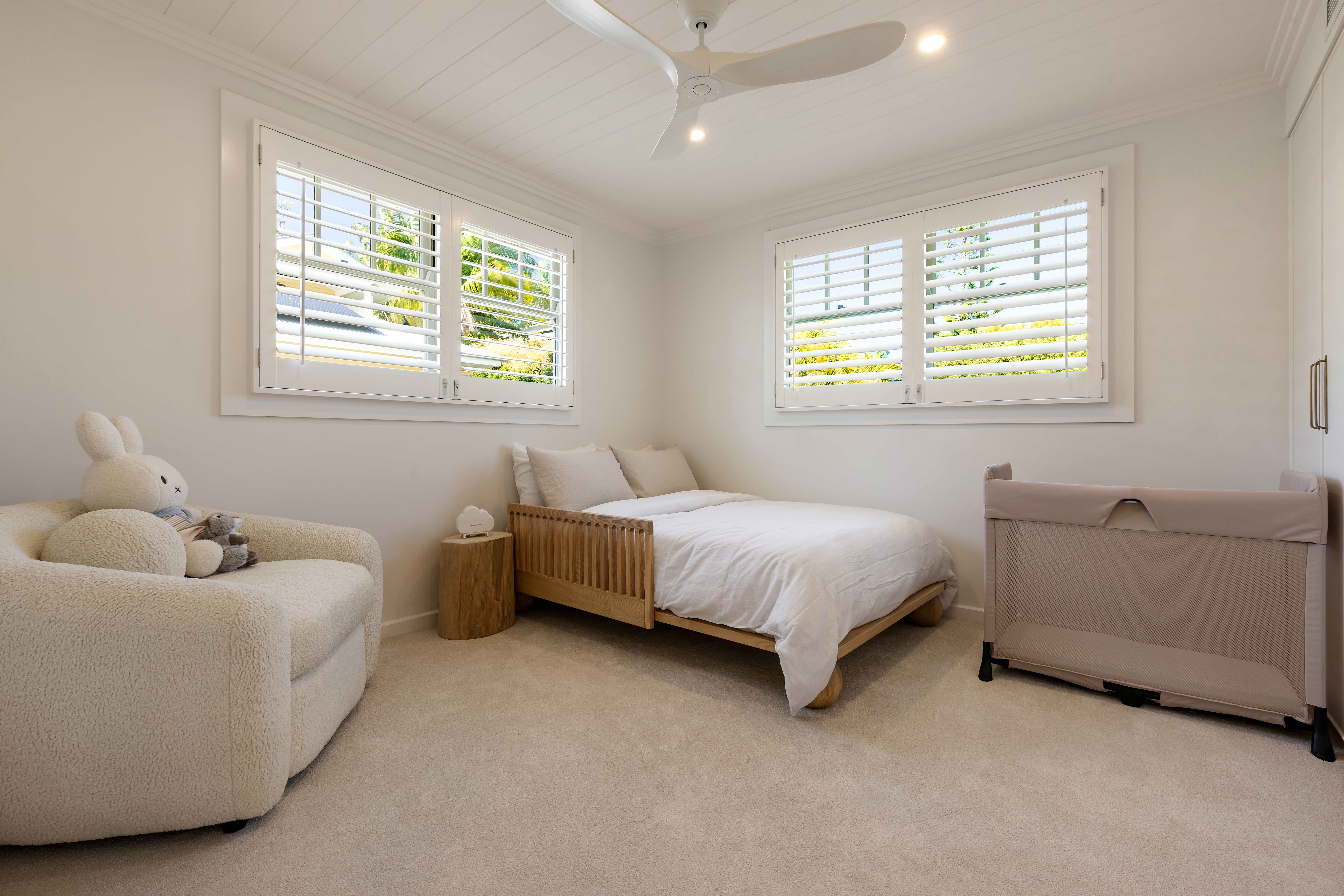 Kids bedroom with oak bed and boucle chair