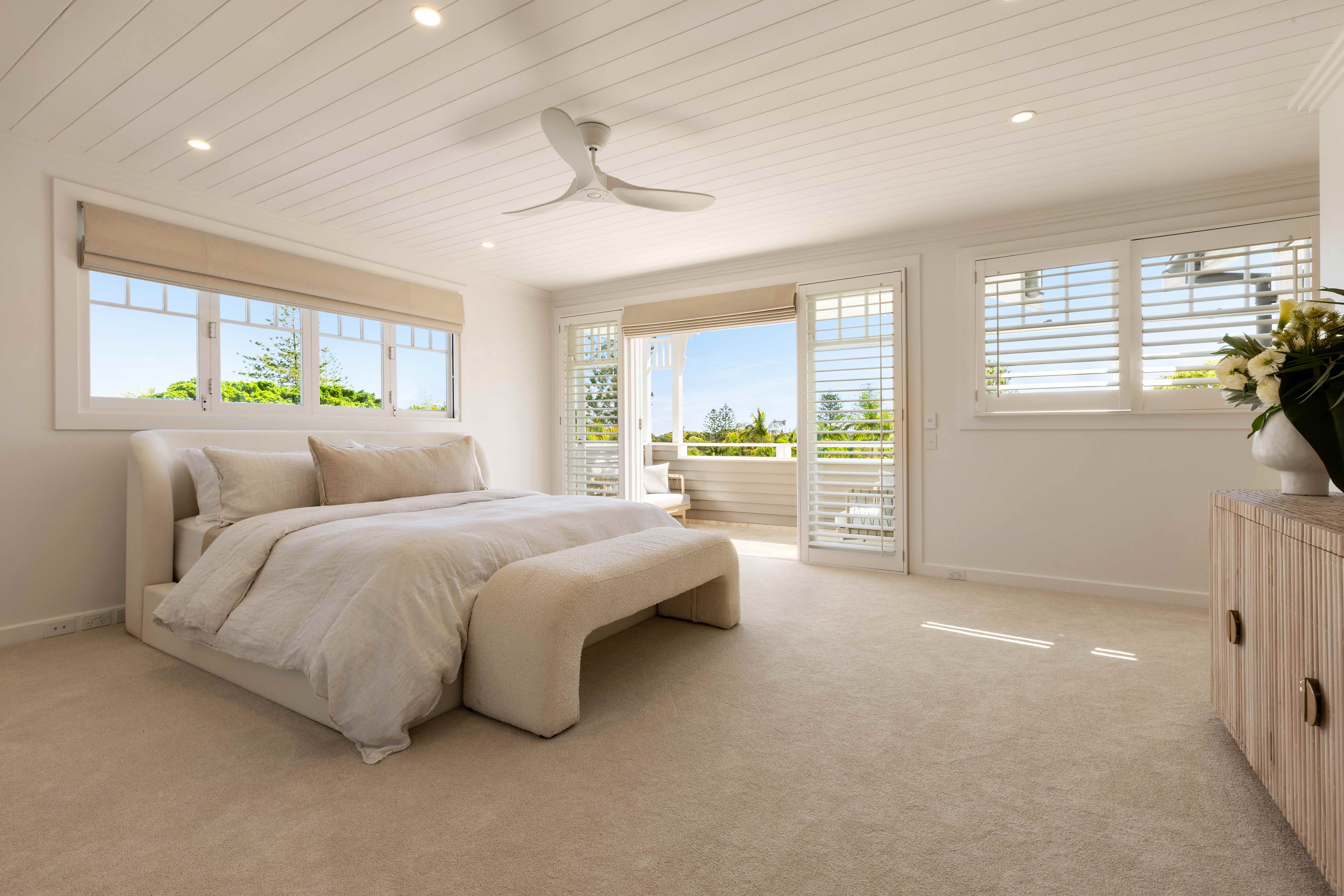Bright master bedroom with plantation shutters