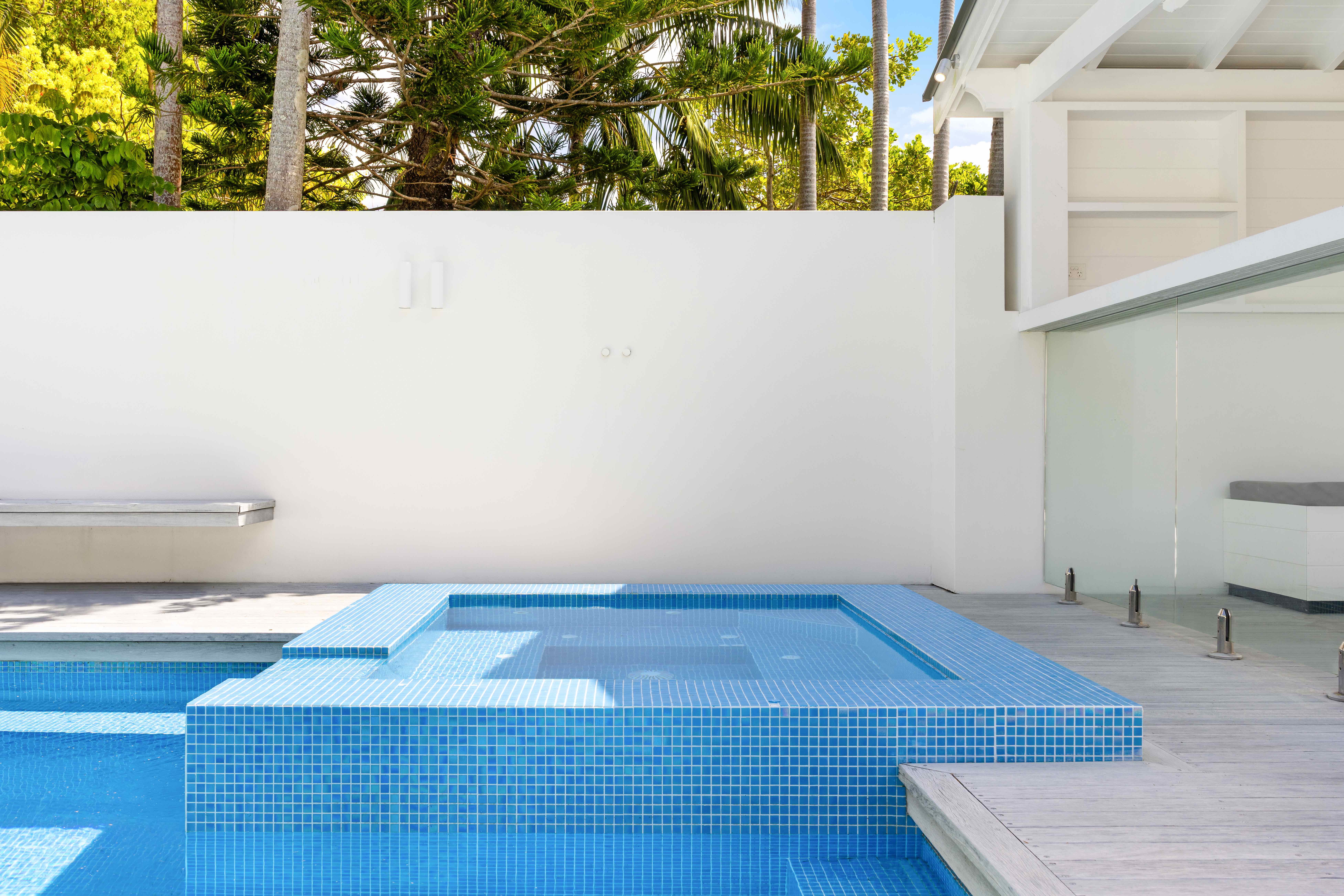 Blue tiled spa and hot tub with pool