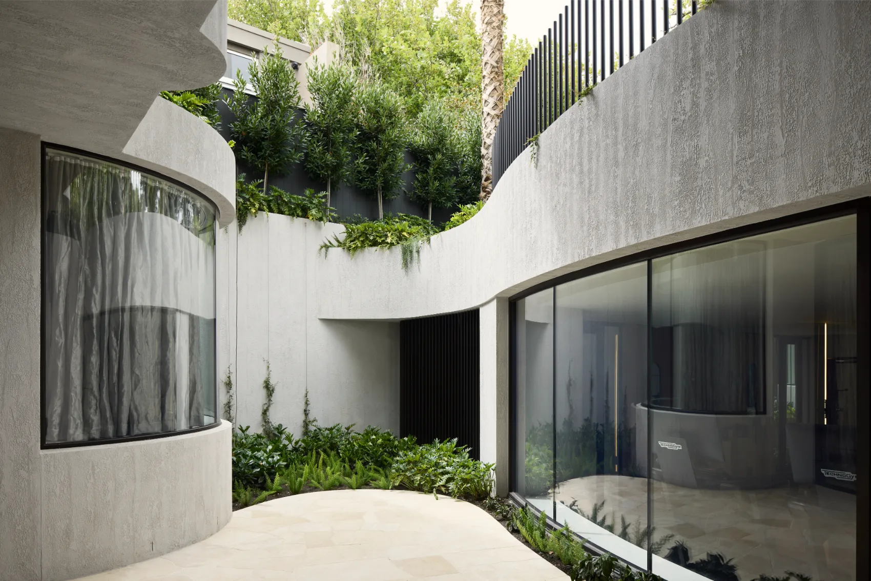 Courtyard garden with curved walls and lush greenery